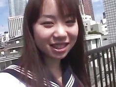 Asian teen poses outdoors before masturbating